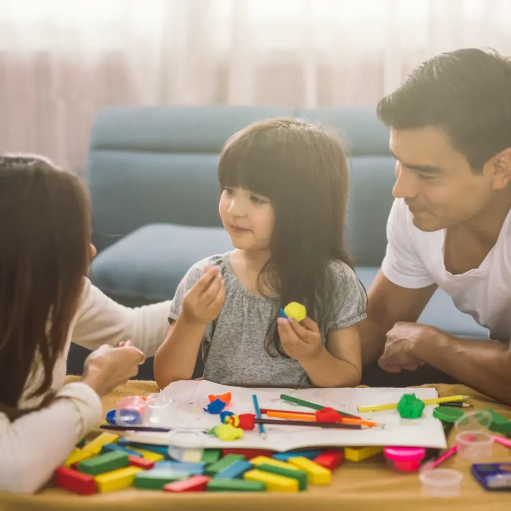 Parent are having a fun time with their daughter